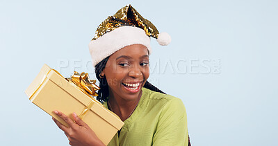 Buy stock photo Happy black woman, box and Christmas surprise for gift, present or prize against a studio background. Face of excited and surprised African female person holding ribbon package, parcel or gifts