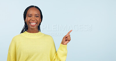 Buy stock photo Pointing, smile and black woman with opportunity, portrait and announcement on a blue studio background. African person, model or girl with hand gesture, mockup space and choice with decision or news