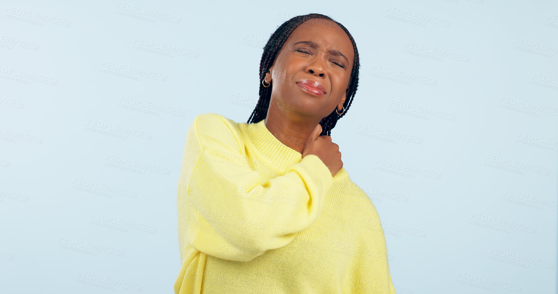 Buy stock photo Neck, pain and injury of woman in studio with stress, risk of arthritis and tired joints on blue background. African model massage spine muscle for first aid, health emergency and crisis of fatigue 