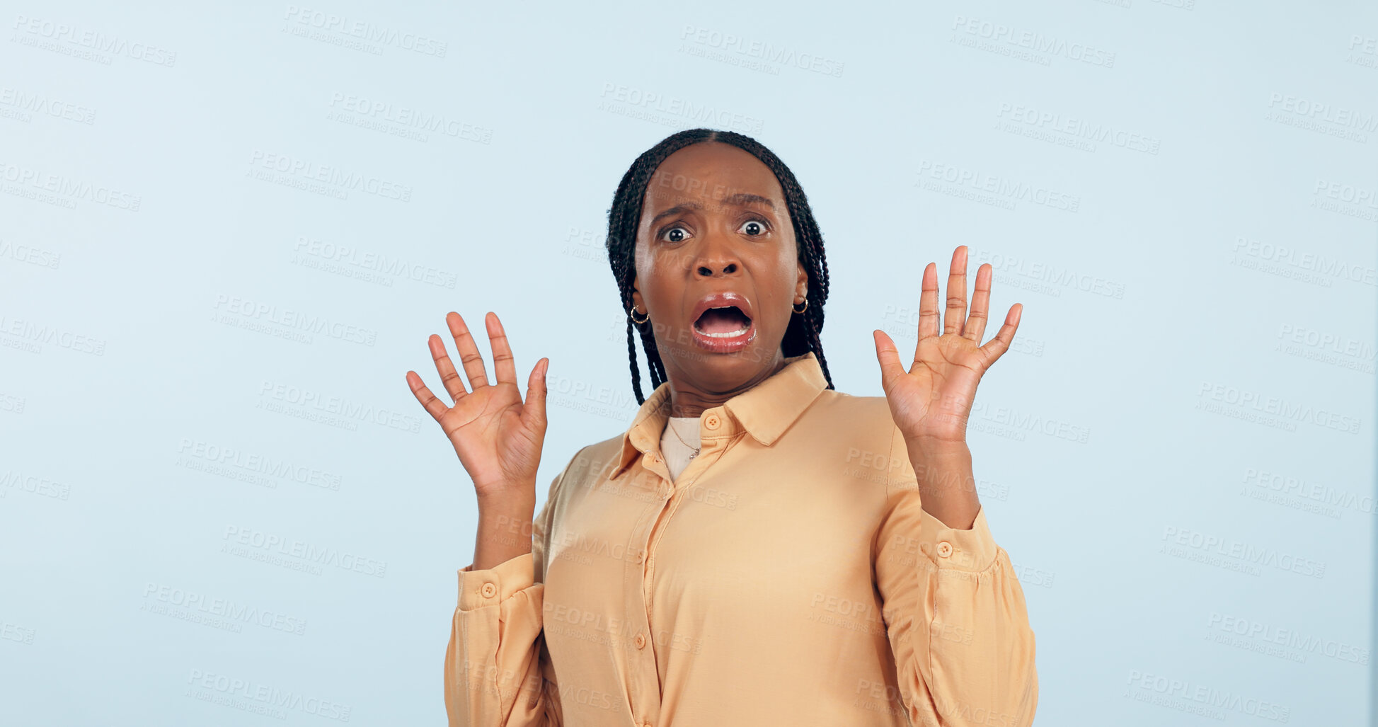 Buy stock photo Black woman, fear and shock in studio portrait for anxiety, drama or secret with hands in air by blue background. African girl, wow and scared face for alarm, surprise or mind blown with announcement