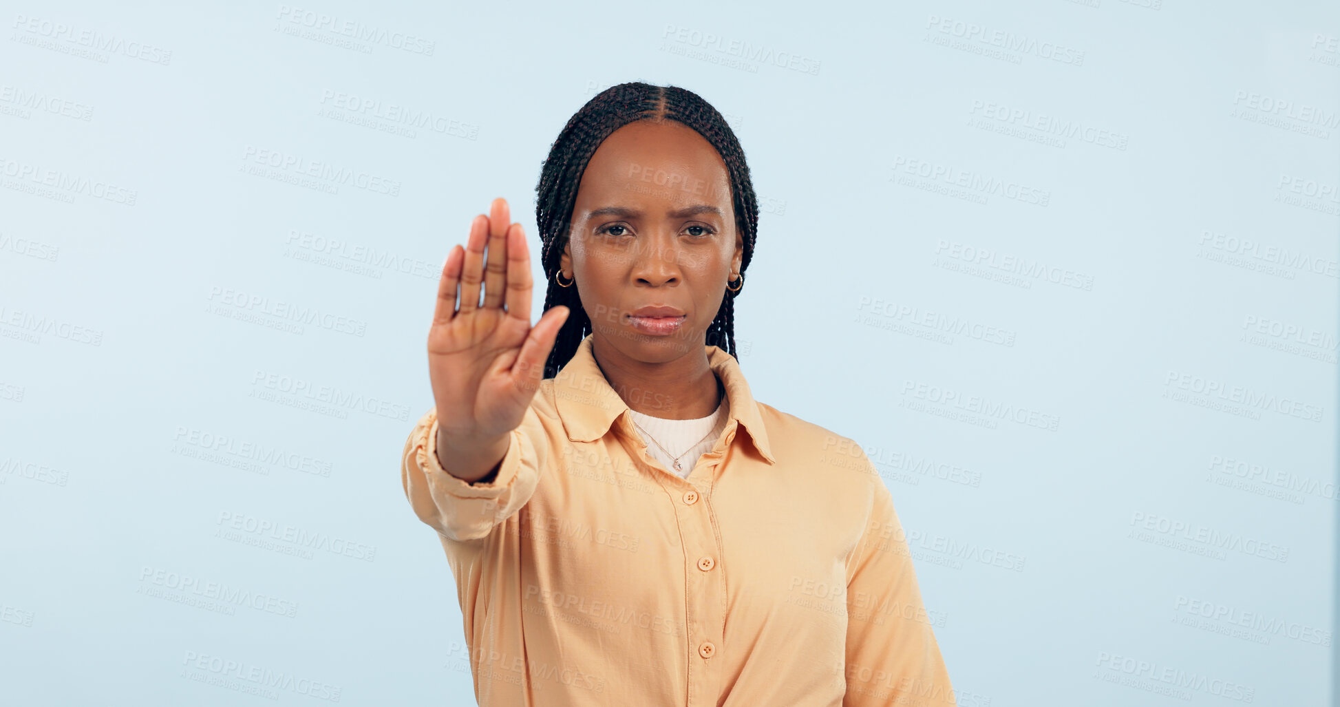 Buy stock photo Serious, stop sign and portrait of black woman in a studio for activism, protest and human rights. Upset, mad and young African female person with open palm hand gesture isolated by blue background.