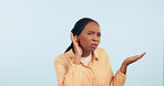 Woman, hand and ear in studio for story, gossip and frustrated face in portrait by blue background. African girl, hearing and confused for secret information, news and communication with questions