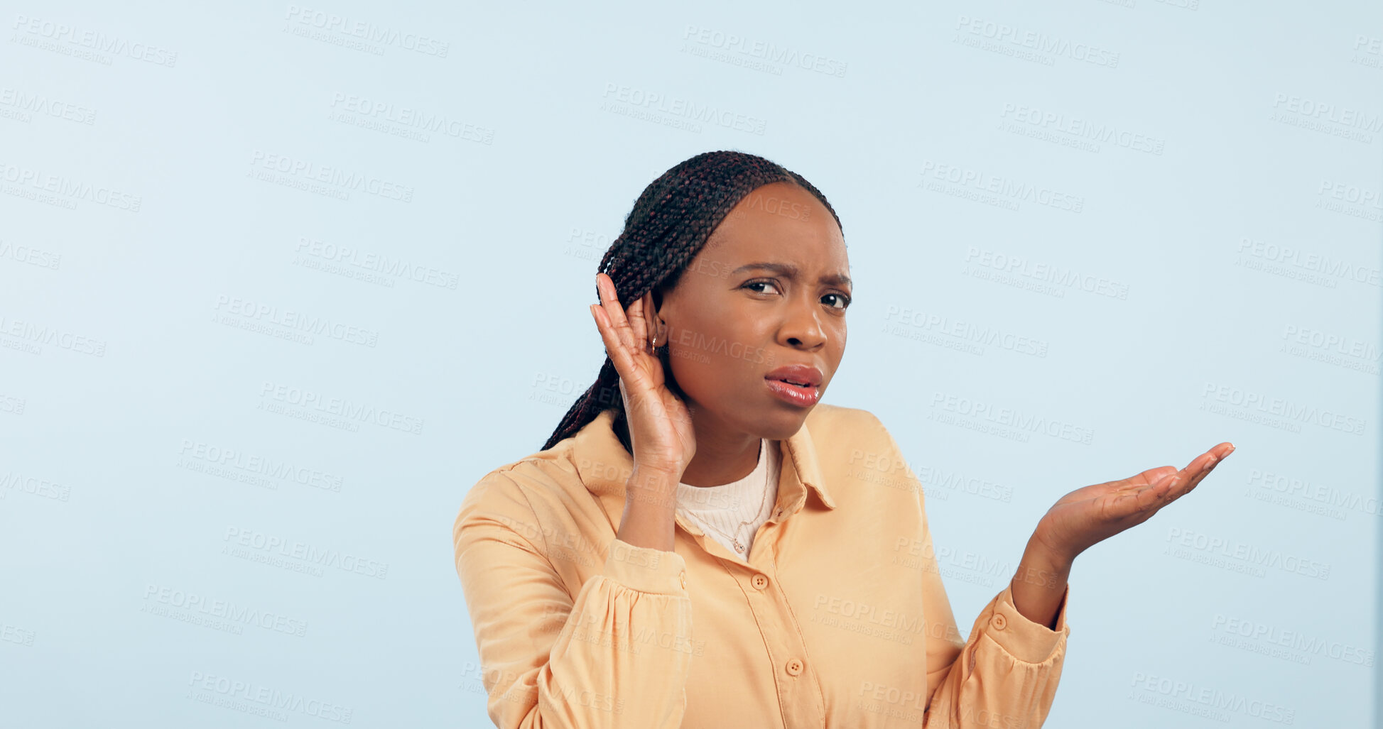 Buy stock photo Woman, hand and ear in studio for story, gossip and frustrated face in portrait by blue background. African girl, hearing and confused for secret information, news and communication with questions