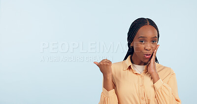 Buy stock photo Woman, point and gossip in studio with space for mockup, portrait and review by blue background. African girl, news or story with presentation, promotion and announcement with secret, info or offer