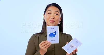 Buy stock photo Asian woman, teacher and flash cards for teaching, education and isolated on studio background. Portrait, learning and show for development, elearning and study for english, animals and presentation