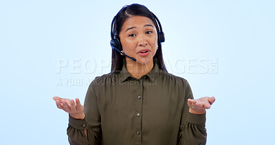 Buy stock photo Portrait, customer service and support with an asian woman consulting in studio on a blue background. Contact us, crm or telemarketing with a young call center employee talking on a headset for help