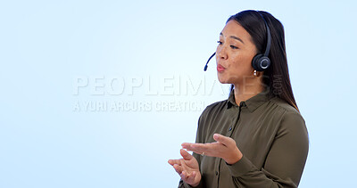 Buy stock photo Space, customer service and support with an asian woman talking in studio on a blue background. Contact us, crm or consulting with a young call center employee telemarketing on a headset for help