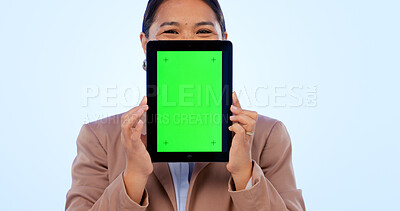 Buy stock photo Portrait, tablet and green screen mockup with an asian woman in studio on a blue background for website promotion. Tech, space or chromakey and a person holding a display with tracking markers