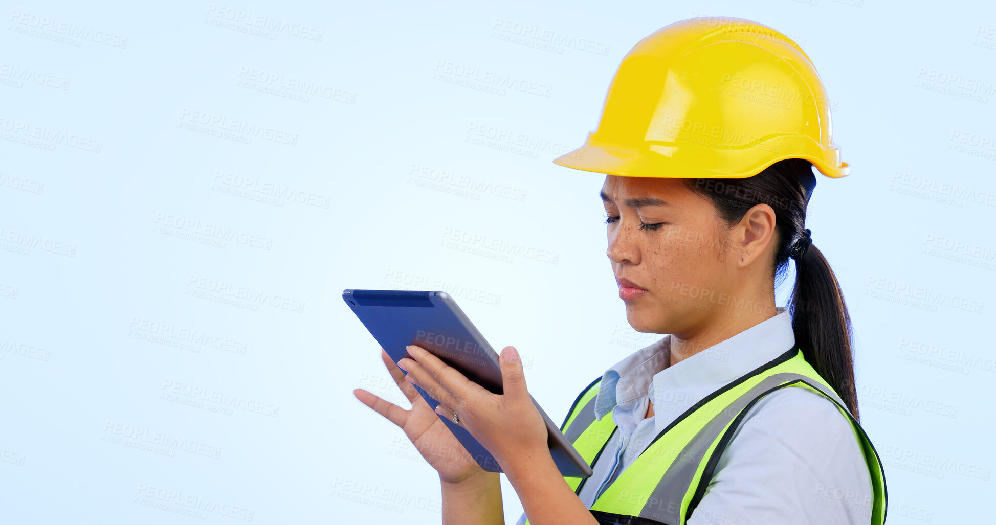 Buy stock photo Woman, engineer and maintenance with tablet for construction, safety and studio by blue background. Asian female, architecture and development or real estate, tech and project management in mockup