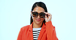 Stylish, cool and a woman with sunglasses on a studio background for fashion, confidence and a trip. Happy, trendy and a girl or person with eyewear for the sun, summer or a vacation on a backdrop