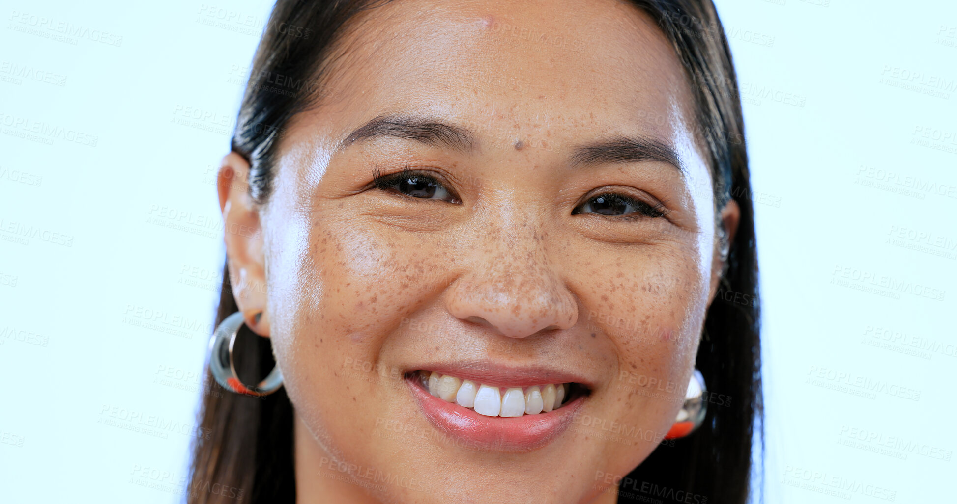 Buy stock photo Happy, smile and portrait of Asian woman in a studio with positive, good and confident attitude. Excited, headshot and closeup face of young female person with happiness isolated by blue background.