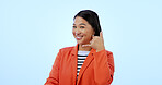 Woman, smile and call me with hand or contact us, networking and portrait in studio by blue background. Happy asian model, emoji and icon for communication, gesture and icon for telephone in mockup