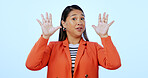 Portrait, warning and woman with stop, rejection and reaction on a blue studio background. Face, person and model with hand gesture, body language and deny with mockup space, feedback and review