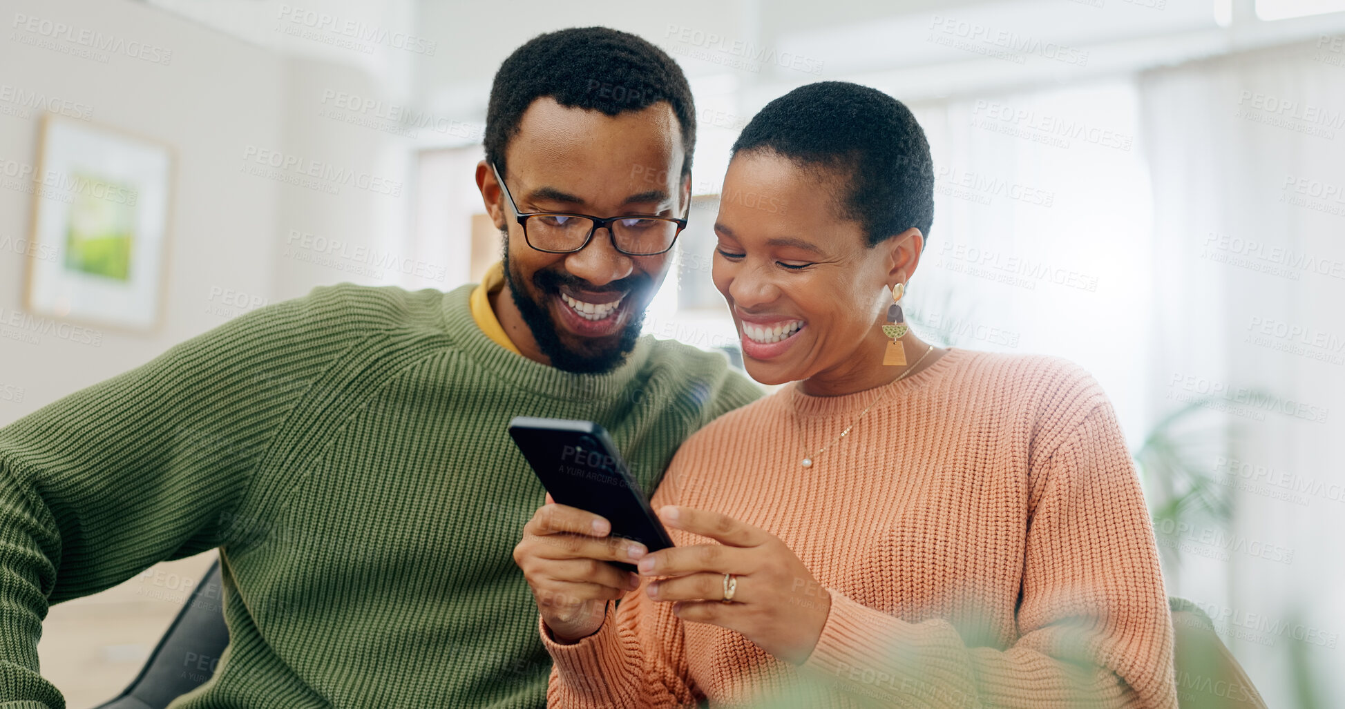 Buy stock photo Happy, home phone and relax black couple reading, smile or watch social media video, blog or relationship news. Smartphone, mobile application and African man, woman or marriage people check web info