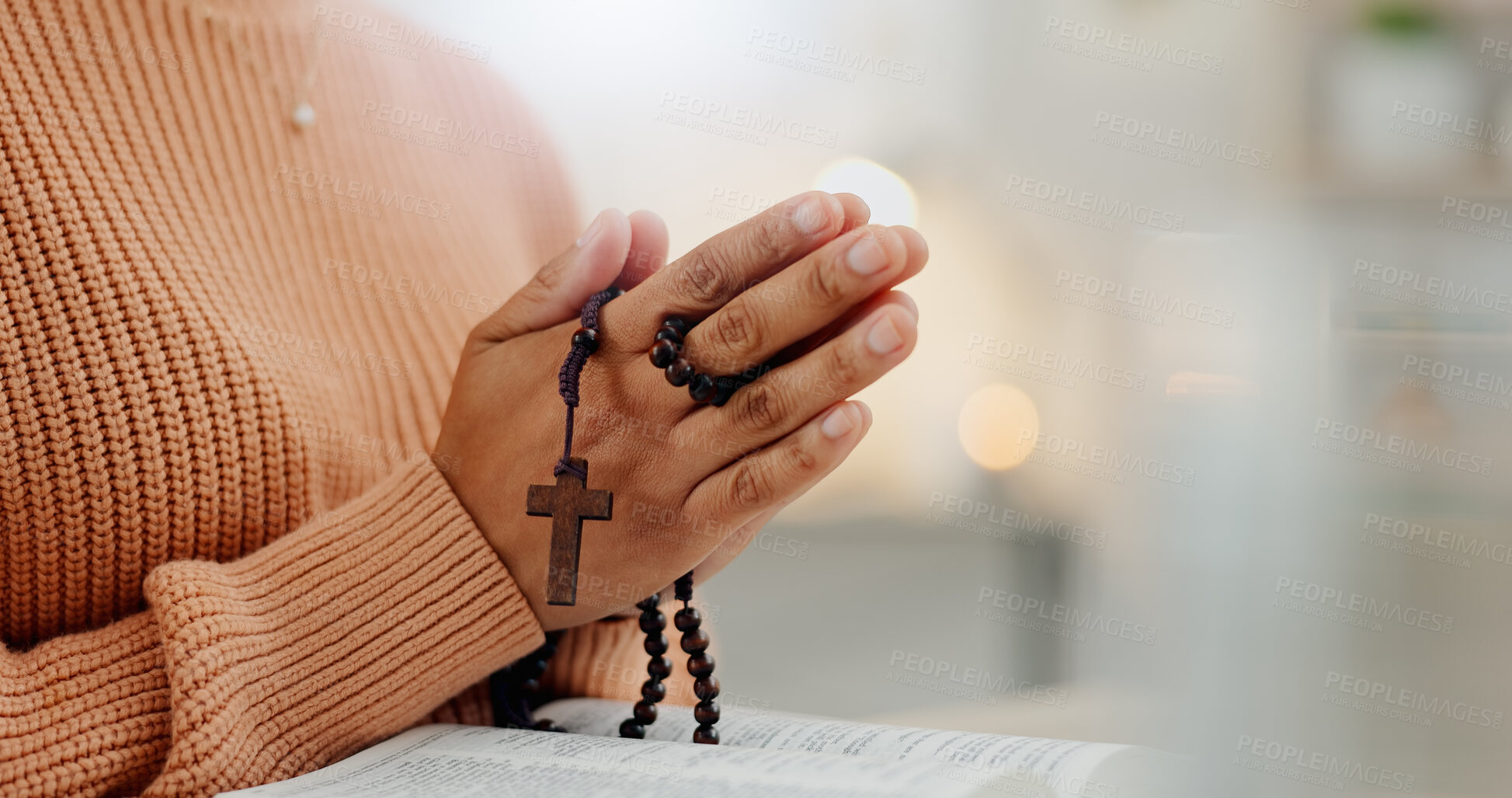 Buy stock photo Closeup hands, rosary and a bible for prayer, spiritual support and hope from Jesus. House, God and a person with a cross and book for help, trust and gratitude as a Christian for the gospel