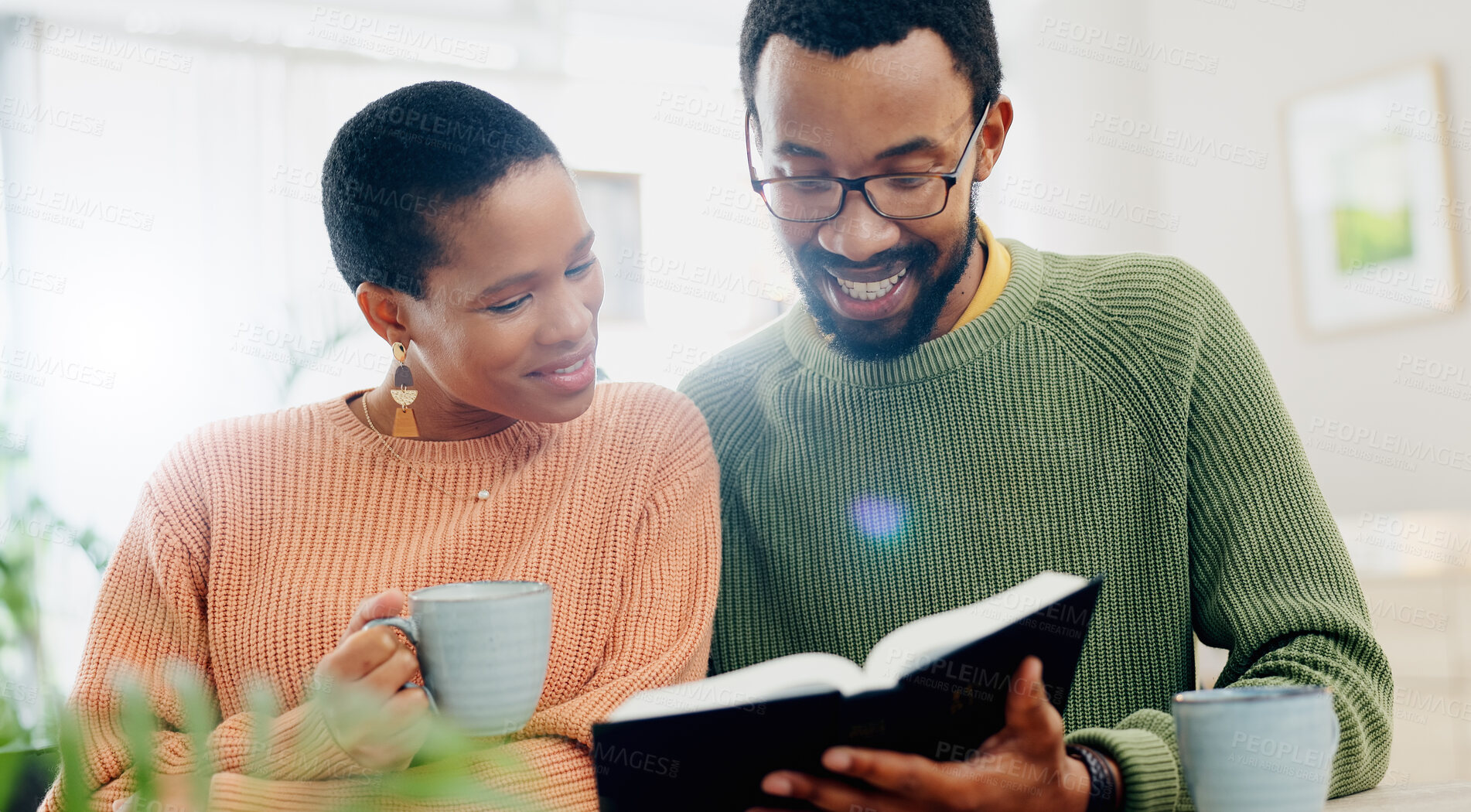 Buy stock photo Home, relax and black couple with smile, reading a book or relax with religion, love or bonding together. Romance, apartment or man with woman, scripture or bible with Christian, hope or conversation