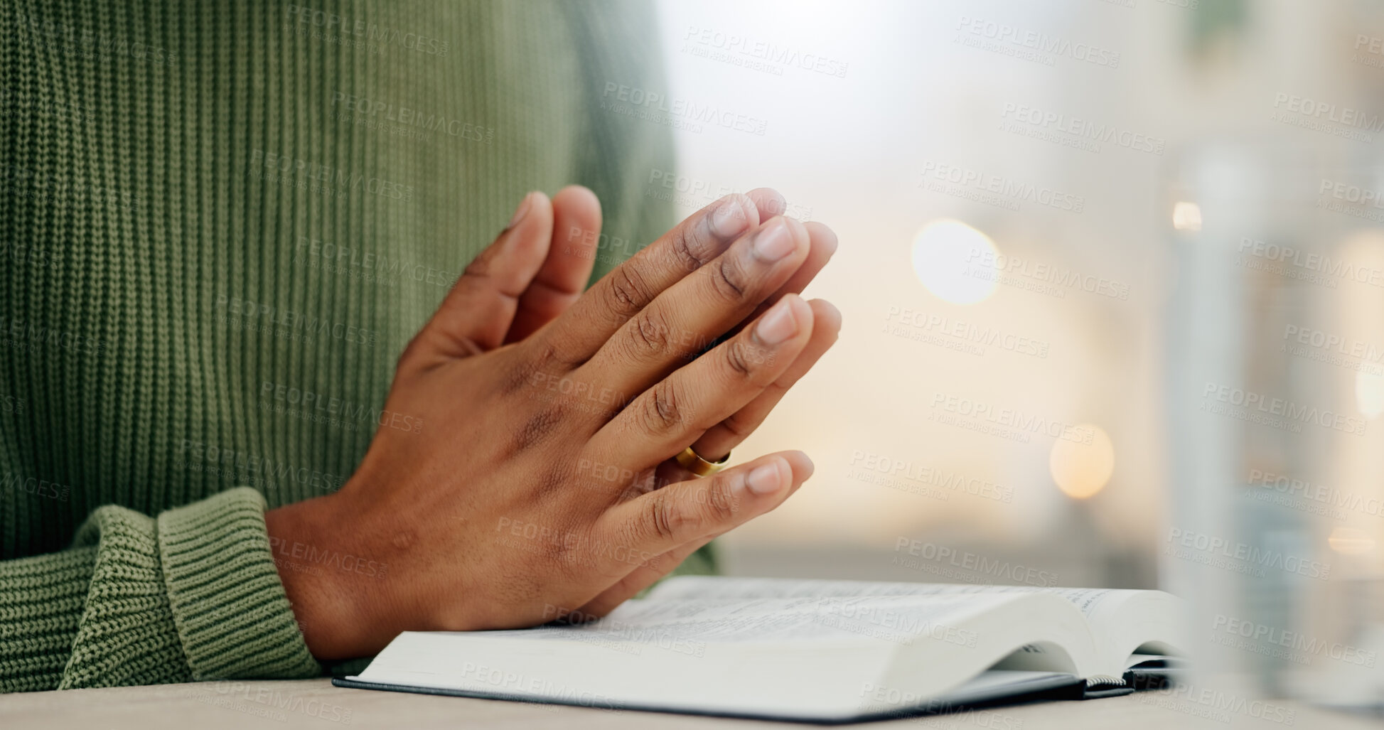 Buy stock photo Home, closeup and person with hands, praying and bible with faith, guidance and religion. Zoom, man and guy with holy book, scripture or prayer with spirit, believe or Christian with worship or peace