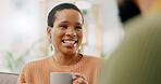 Coffee, discussion and happy woman at home on a living room sofa with a man and hot drink. Couple, tea and smile with communication and conversation together with love and marriage support on a couch