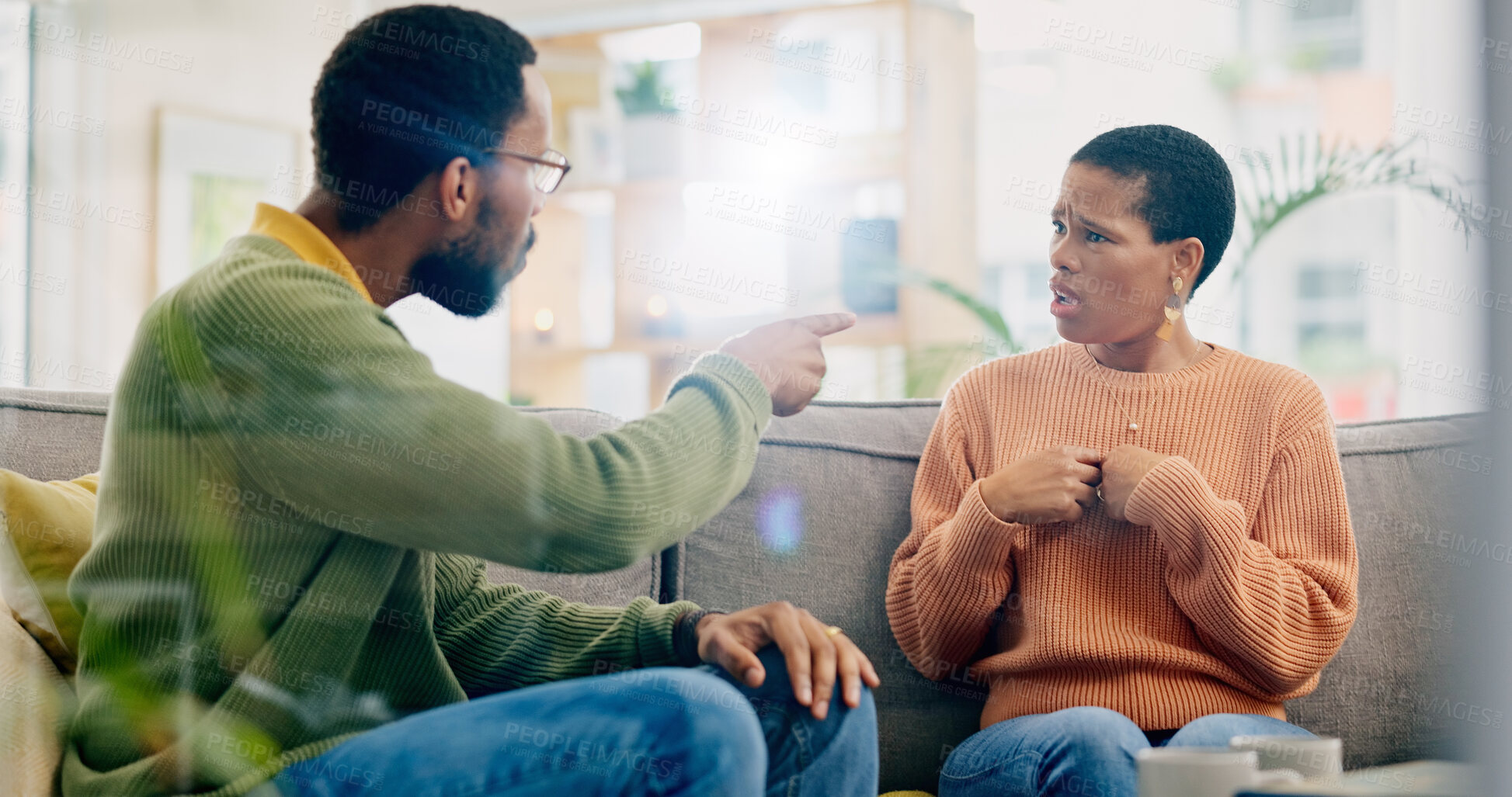 Buy stock photo Fight, couple and home with marriage problem, frustrated and angry man on a living room sofa. Mistake, yelling and conversation of people with argument, fail and conflict with divorce discussion