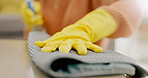 Cleaning, cloth and hands with furniture in living room for hygiene, housework and maintenance in home. Housekeeping, closeup and person with gloves on table for bacteria, dirt and dust on surface