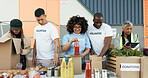 Group of people, volunteering and groceries on table for charity event with care, kindness and help. Community donation, men and women at ngo checking food package distribution at non profit project.