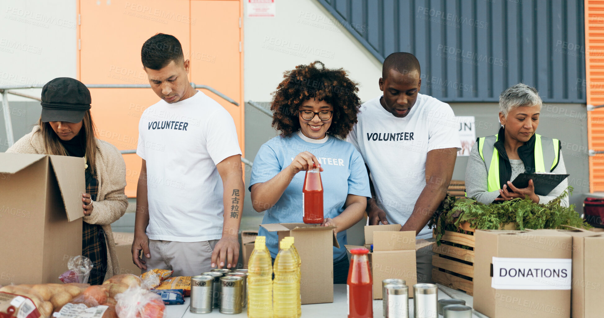 Buy stock photo Group of people, volunteering and groceries on table for charity event with care, kindness and help. Community donation, men and women at ngo checking food package distribution at non profit project.