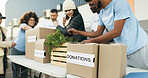 Teamwork, people volunteering and food boxes on table for charity event with care, kindness and trust. Community donation, men and women at ngo with grocery package distribution at non profit project