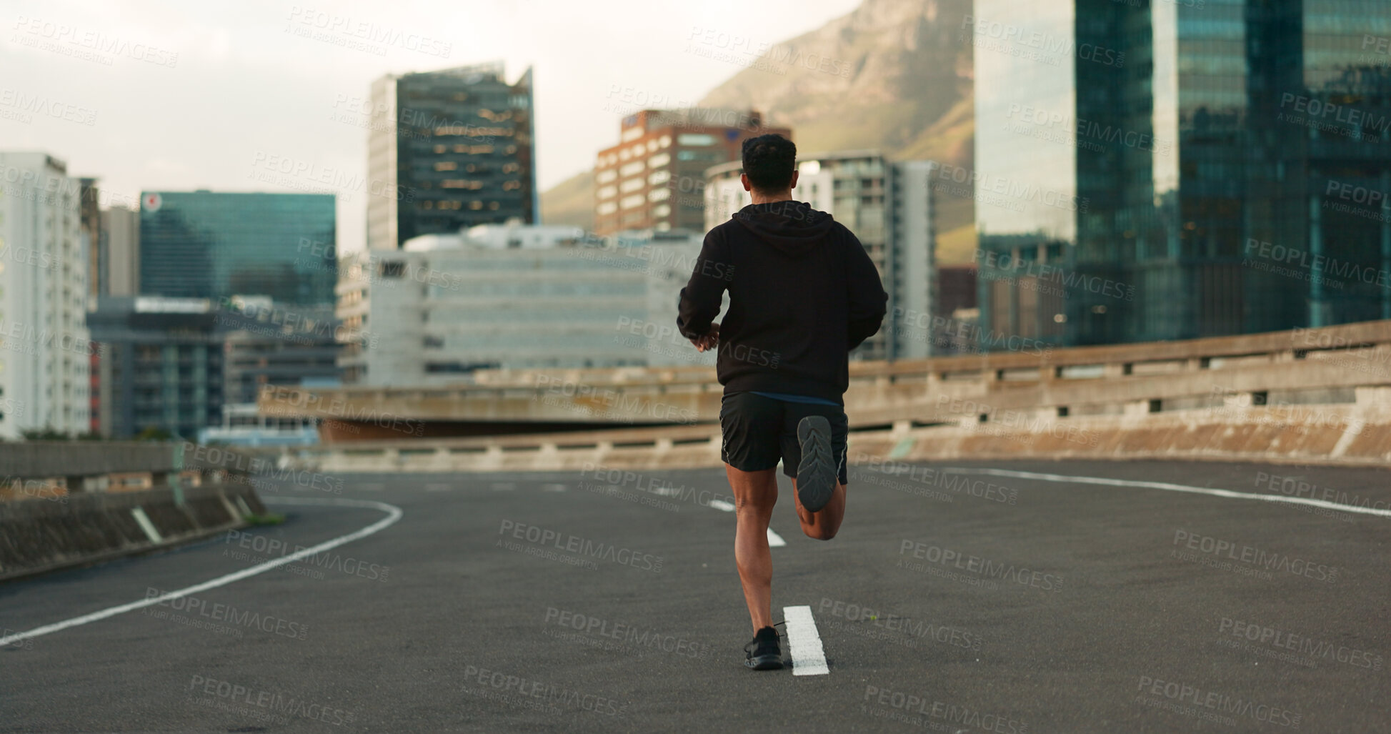 Buy stock photo Man, back and running in morning on city, street and bridge for fitness, workout and marathon training. Athlete, person or exercise on South Africa road for wellness, health or triathlon performance