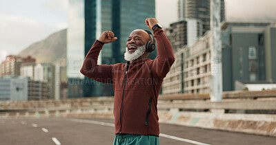 Buy stock photo Exercise, celebration and senior man, headphones, city and achievement with workout, streaming music and radio. African person, pensioner and runner with headset, progress and fitness wellness or joy