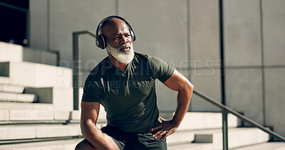 Buy stock photo Fitness, headphones and black man on steps in city, sweat after workout and exercise for body health. Music, senior athlete and stairs in urban town, listening to audio and serious, thinking or relax