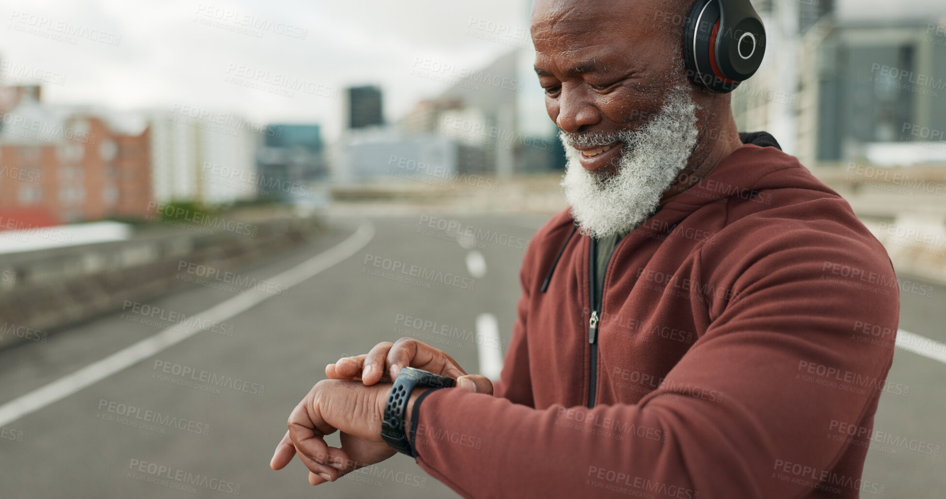 Buy stock photo Man, music and smart watch in city for workout, cardio performance and exercise results. Happy senior african runner, sports gear and timer for clock, healthy training progress and headphones in road