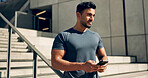 Fitness, phone and man in city on stairs after exercise, workout and training break. Smartphone, athlete and Indian person on steps outdoor, typing on mobile app, social media and thinking to relax