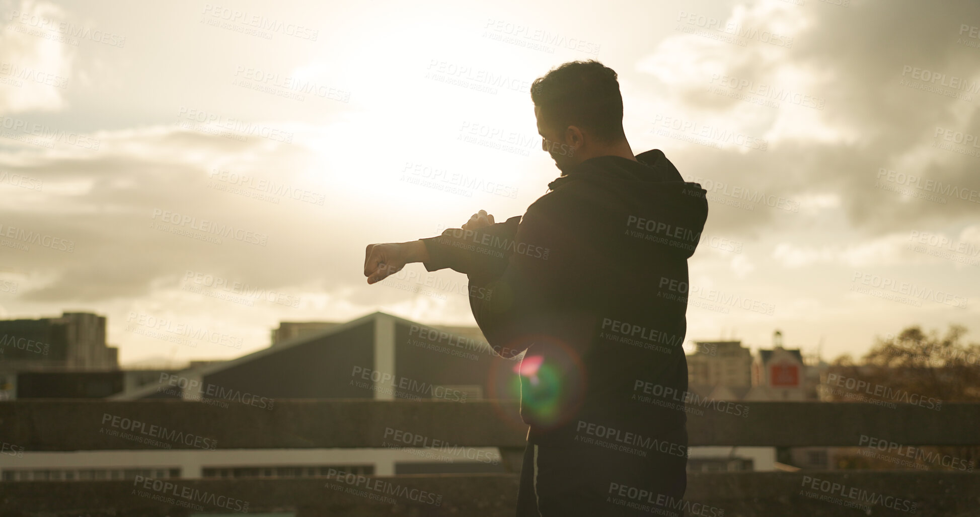 Buy stock photo Man, stretching and fitness in city for workout, exercise or outdoor training with cloudy sky. Rear view, male person or athlete in flare, body warm up or arm stretch getting ready in an urban town