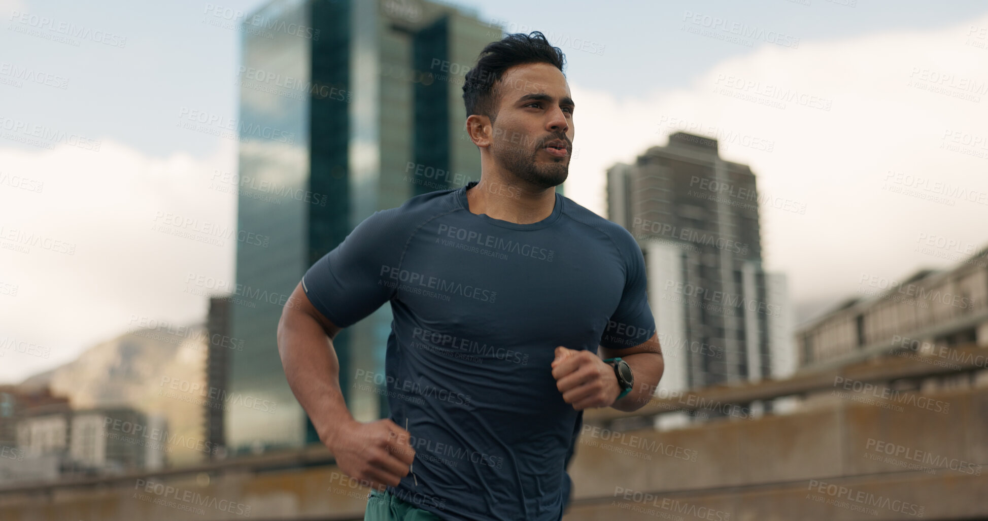 Buy stock photo Exercise, running and a sports man in the city for cardio training to improve fitness for a marathon. Wellness, workout or health with a young runner or athlete in an urban town for a speed challenge