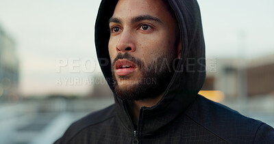 Buy stock photo Fitness, breathing and thinking, man in city on rest from morning wellness workout in hoodie. Relax, face and tired athlete on calm urban exercise with fatigue, reflection and outdoor air on street.