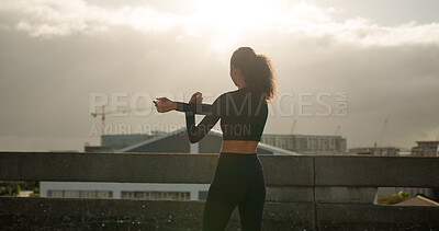 Buy stock photo Woman, stretching and fitness in city for workout, exercise or outdoor training in sunset. Rear view of female person, runner or athlete in body warm up or arm stretch getting ready in an urban town