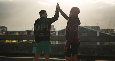 Man, high five and fitness in city for workout, training or success in outdoor exercise together. Male person, athlete or team touching hands for winning, teamwork or sports achievement in urban town