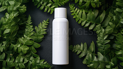 White blank hairspray container on a green leafy backdrop. For organic or eco friendly product