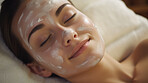 Woman wearing mask on face in spa beauty salon. Relaxed woman, skin beauty treatment