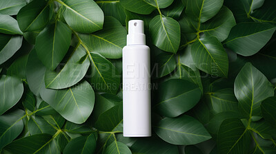White blank hairspray container on a green leafy backdrop. For organic or eco friendly product