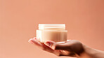 Close up of hand holding a jar of cosmetic product. Skincare hygiene moisturiser