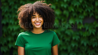 Buy stock photo Portrait of young happy female, wearing a green t-shirt against a plant wall for eco friendly