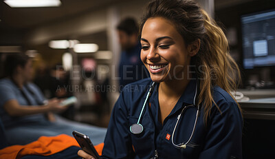Happy nurse smiling at phone in surgery. Medical concept.