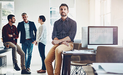 Buy stock photo Portrait of a young man with his colleagues having a discussion in the background