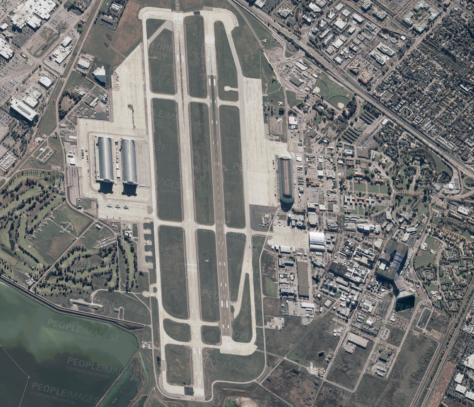 Buy stock photo Aerial city, drone and landing strip view of urban road, building and cityscape outdoor of town. Airport, skyline and above with streets, travel and architecture with commercial development from top