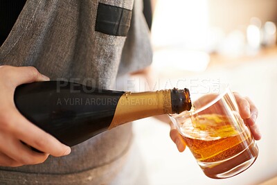 Buy stock photo Cropped view of a woman's hands pouring a drink