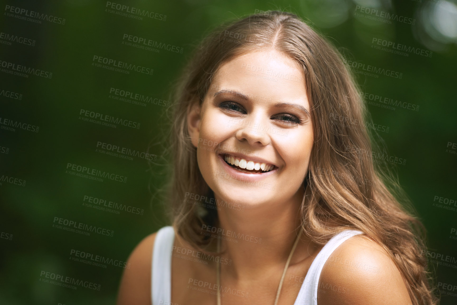 Buy stock photo Portrait, smile and a woman in the forest on a green background for freedom, travel or to relax. Face, beauty and a happy young person in the countryside or woods for wellness or stress relief
