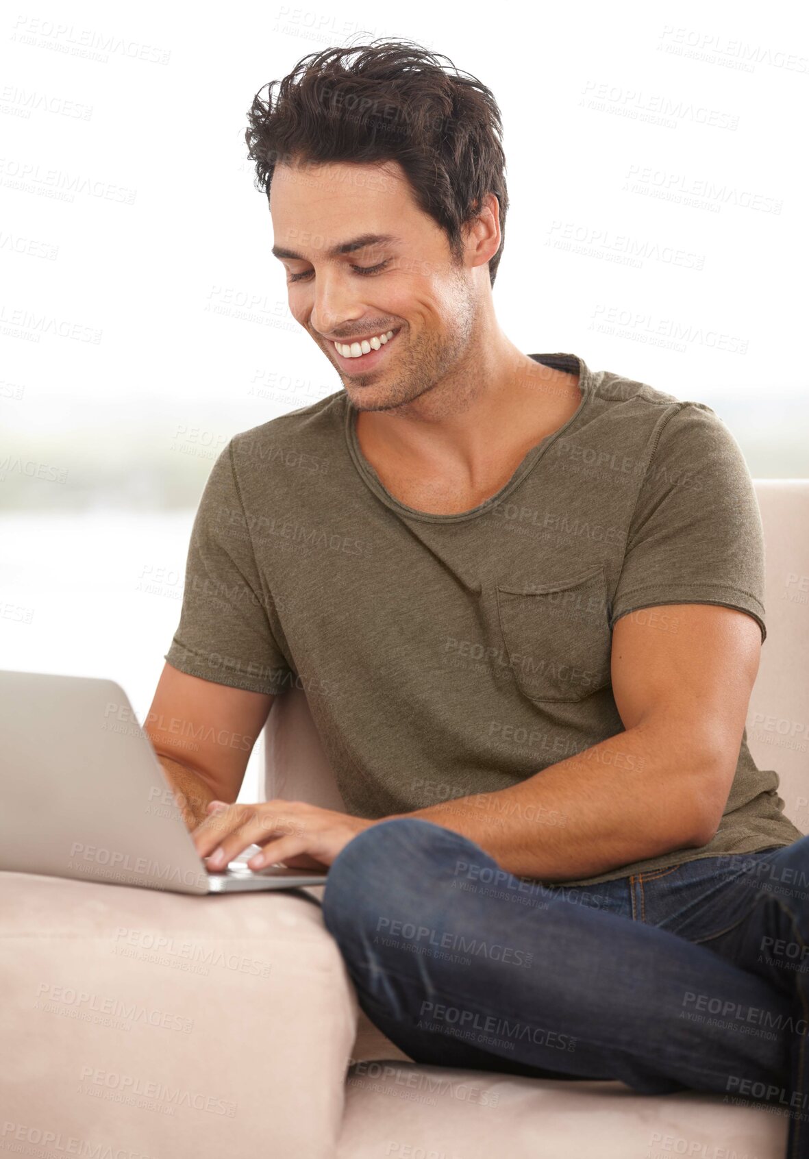 Buy stock photo A handsome young man working on his laptop at home