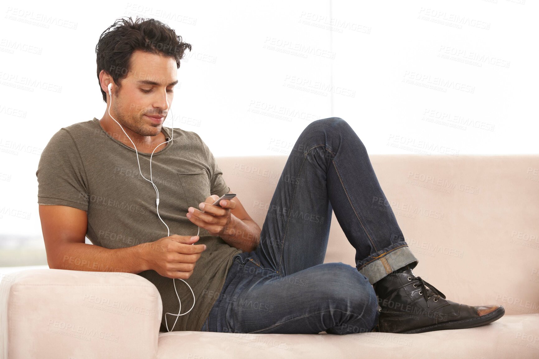 Buy stock photo Relax, technology and a man with music on the sofa, streaming and calm in a house. Happy, home and a person on the living room couch listening to a podcast, audio or radio on digital tech online