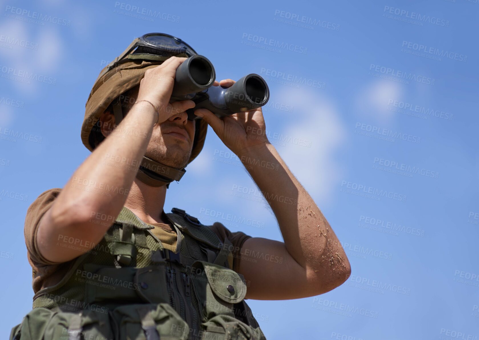 Buy stock photo A young soldier looking through his binoculars